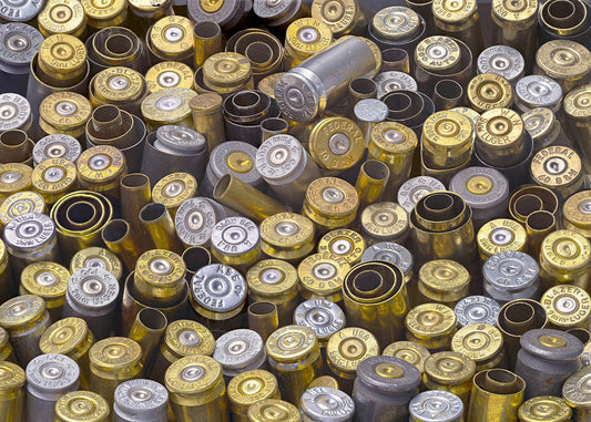 A high-resolution, detailed collage print of spent brass and silver bullet casings with stamped manufacturer markings.