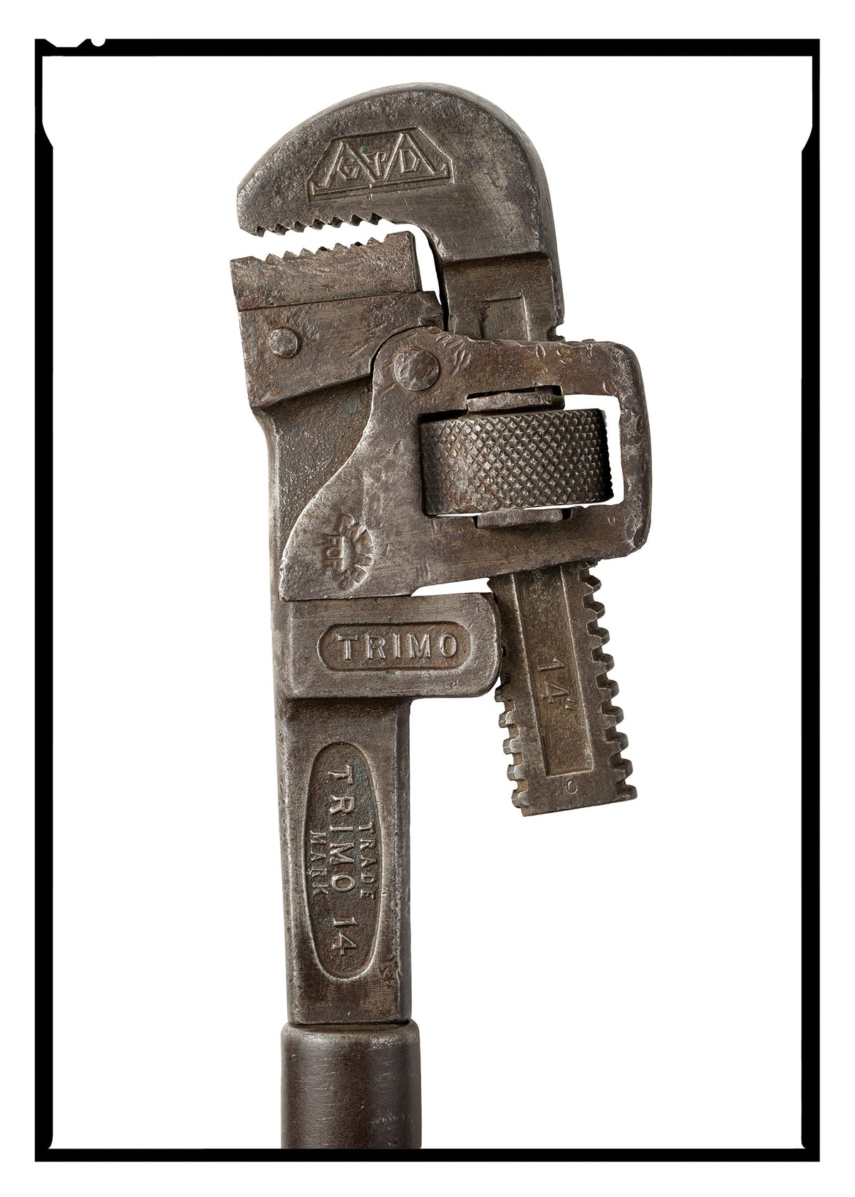 A high-resolution fine art print of an antique 14-inch Trimo pipe wrench front view, isolating forged steel details against white.